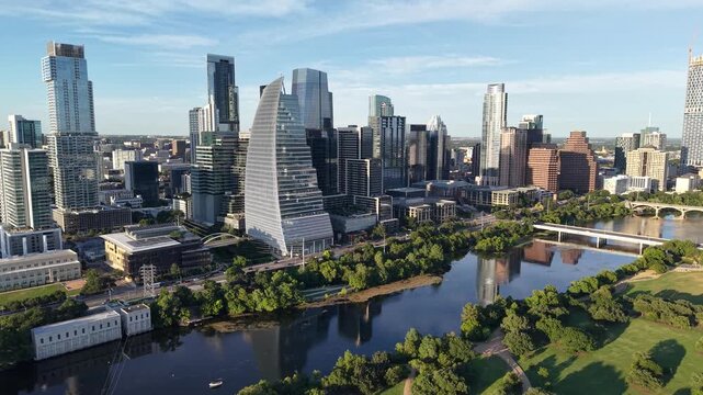 Aerial drone 4k Austin downtown skyline an hour before sunset overlooking the Colorado river or Lady Bird Lake