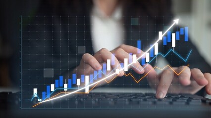 A businesswoman examines data trends on a computer, highlighting financial growth with colorful graphs and statistics in a modern office environment. Copula
