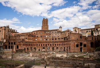 Ancient brick ruins of Trajan Market in Rome under cloudy blue sky
