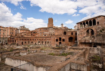 Ancient brick ruins of Trajan Market in Rome under cloudy blue sky