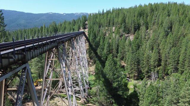 Clio trestle in northern California. Flight starts as a low angle shot along the deck, featuring the support structure, then rises and flies over the trestle.