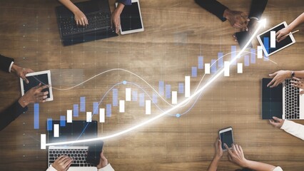 A diverse group of professionals collaborating on digital devices to analyze financial data, charts, and market trends. This image showcases a modern workspace environment. Copula