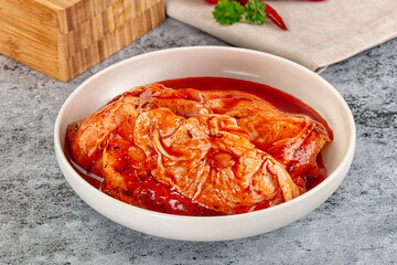 Raw chicken marinated thighs with skin