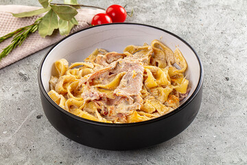 Italian pasta fettuccine with prosciutto