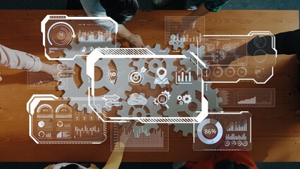 A diverse team collaborates on business strategy using data analytics tools, visual interfaces, and gears, highlighting teamwork and innovative processes in a modern workspace. Raster