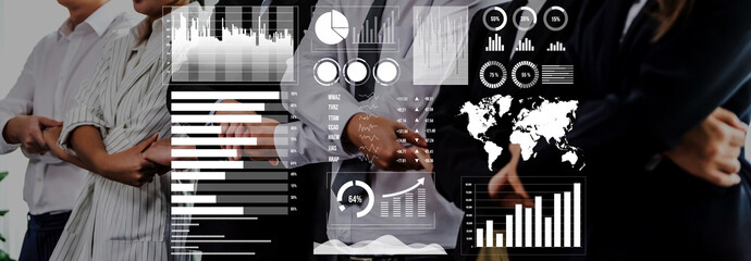 A business team engages in collaboration, showcasing digital graphs and data visualizations that enhance strategic planning and informed decision making in a modern office. Axiom
