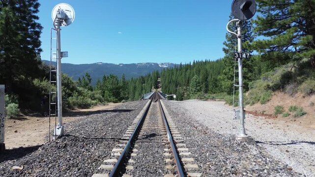 Clio trestle in northern California. Flight passes between two signal lights then rises to show the trestle.