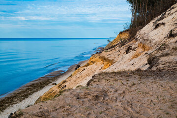Baltic sea landscape with gold sand dune and calm water without waves