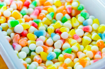 Pile of colorful glazed dragees. Shiny candies in a sugar crust. A background of glazed or chocolate-covered nuts