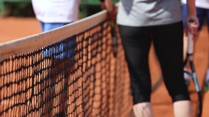Tennis tournament championship on outdoor clay court with net, professional athletes play in motion with rackets serve tennis ball during tennis match game, tennis training in a sunny day on a stadium