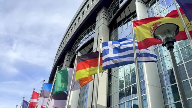 European Union Flags Waving Near European Parliament Building In Brussels, Belgium