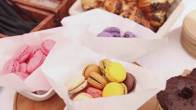 Beautiful multicolored decorated baked sweet tasty candy bar dessert selection with cake, pie and pastries selection, catering banquet table on kids children party, coffee break buffet at a conference