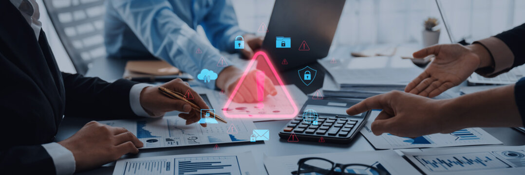 Professionals collaborating in a modern office, analyzing financial data and discussing risk management while incorporating digital security symbols for effective strategy planning. Trope