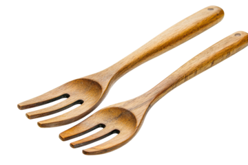 Two wooden salad forks with three prongs each on a transparent background studio shot