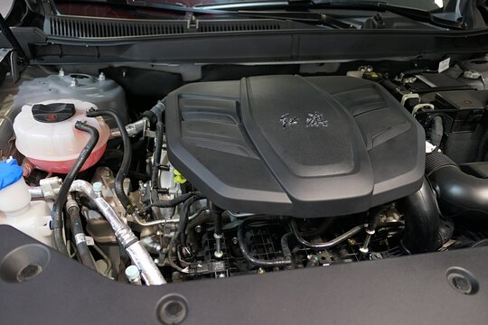 2.0 litres turbo petrol straight-four engine visible in opened trunk of modern chinese compact luxury crossover SUV car Hongqi HS5, displayed on car expo in Nitra, Slovakia, october 2025. 