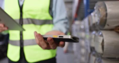 Close up of logistics workers hand using handheld barcode scanner