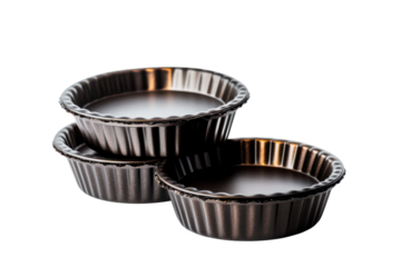 A stack of three small metal tart pans on transparent background