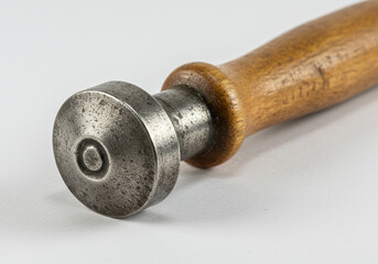 Close-Up of Vintage Stamp or Punch Tool with Wooden Handle