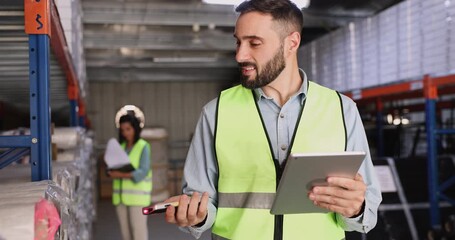 Male warehouse worker check inventory on shelves - Powered by Adobe