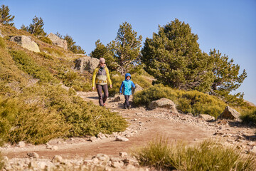 Mother and son descending a mountain path