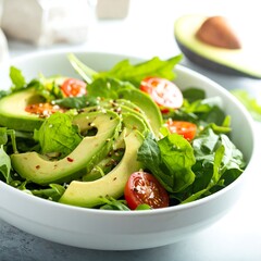 Fresh salad with avocado, spinach, and cherry tomatoes