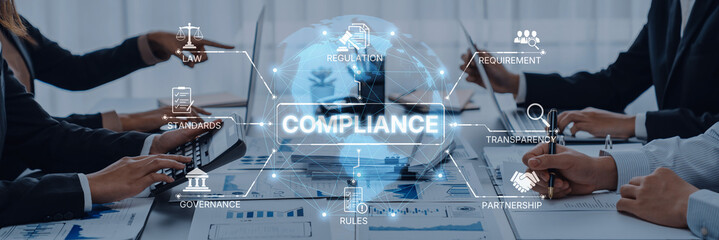 Business professionals collaborate in a modern office setting, discussing compliance strategies with digital elements illustrating governance and regulatory concepts. Trope
