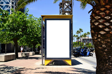 bus shelter with vertical blank ad panel. billboard display. empty white lightbox sign at bus stop. mockup base. city transit station. urban street. park setting with palm trees. outdoor advertising