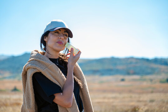 Beautiful Woman applying sunscreen spf stick in the autumn mountain 