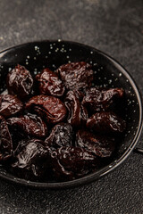 Prunes smoked plum portion size natural product tasty snack fresh delicious gourmet food background on the table rustic top view copy space keto and paleo diet vegetarian and vegan food