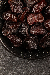 Prunes smoked plum portion size natural product tasty snack fresh delicious gourmet food background on the table rustic top view copy space keto and paleo diet vegetarian and vegan food