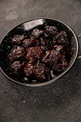 Prunes smoked plum portion size natural product tasty snack fresh delicious gourmet food background on the table rustic top view copy space keto and paleo diet vegetarian and vegan food