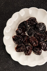 Prunes smoked plum portion size natural product tasty snack fresh delicious gourmet food background on the table rustic top view copy space keto and paleo diet vegetarian and vegan food
