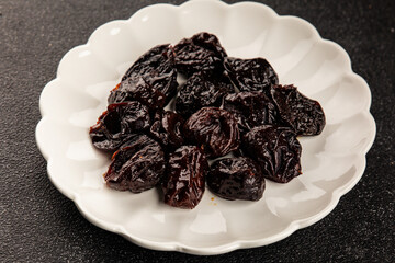 Prunes smoked plum portion size natural product tasty snack fresh delicious gourmet food background on the table rustic top view copy space keto and paleo diet vegetarian and vegan food