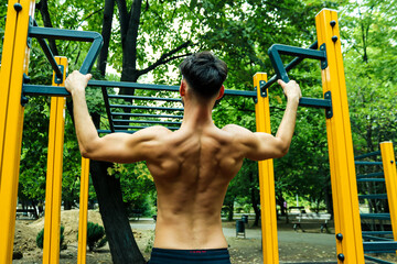Fototapeta premium Man working out in Calisthenics Park
