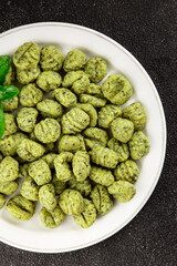 Gnocchi spinach potato dough second course portion size natural product tasty snack fresh delicious gourmet food background on the table rustic top view copy space