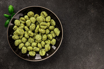 Gnocchi spinach potato dough second course portion size natural product tasty snack fresh delicious gourmet food background on the table rustic top view copy space