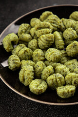 Gnocchi spinach potato dough second course portion size natural product tasty snack fresh delicious gourmet food background on the table rustic top view copy space