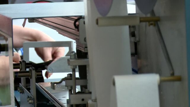 High-speed industrial circular knitting machine weaves textile threads with precision. Complex mechanical parts show modern automated production and efficiency in textile manufacturing.