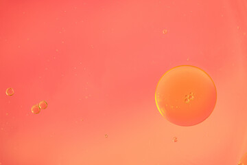 Macro shot of floating transparent bubbles of various sizes in water on a soft orange background. Minimal, clean composition with gentle gradient, perfect for banner or cosmetic concept. Copy space