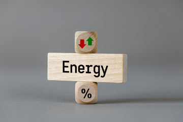 Energy price . Wooden blocks with arrows symbolizing the increase or decrease in costs. The symbol of a percentage. Business and economic concept. close up