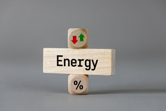 Energy price . Wooden blocks with arrows symbolizing the increase or decrease in costs. The symbol of a percentage. Business and economic concept. close up
