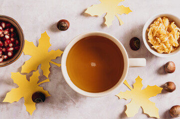 Close up of autumn tea in a cup with apple croutons on a plate on the table top view