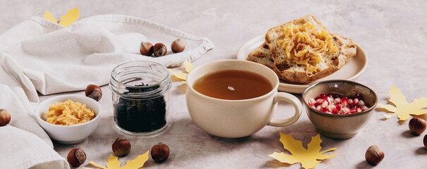 Autumn tea in a cup with apple croutons on a plate on the table web banner