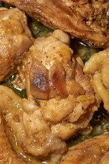 Pieces of chicken meat are fried in a frying pan, exuding flavor and mouth-watering appearance. Delicious chicken pieces are fried in a frying pan until golden brown.