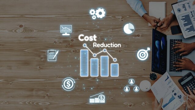 A collaborative business meeting centered on cost reduction strategies, showcasing financial graphs, digital icons, and tools for planning and efficiency. Raster
