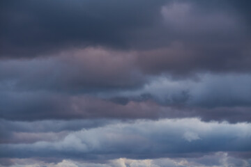 Dramatic dark storm clouds fill the sky, a moody and ominous natural background before a thunderstorm or heavy rain.