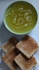 Chicken Broth With Spices And Croutons. Warm chicken broth with spices and croutons served in a bowl, comforting and soothing during illness.
