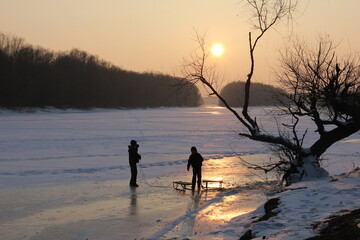 frozen river's edge as golden sunset light
