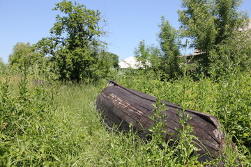 abandoned wooden boat, weathered to deep burgundy