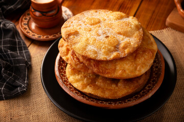 Mexican Buñuelos. Traditionally fried wheat tortillas used for Christmas and winter holidays, these are fried flour tortillas sprinkled with sugar or covered in a syrup made with piloncillo, cinnamon,